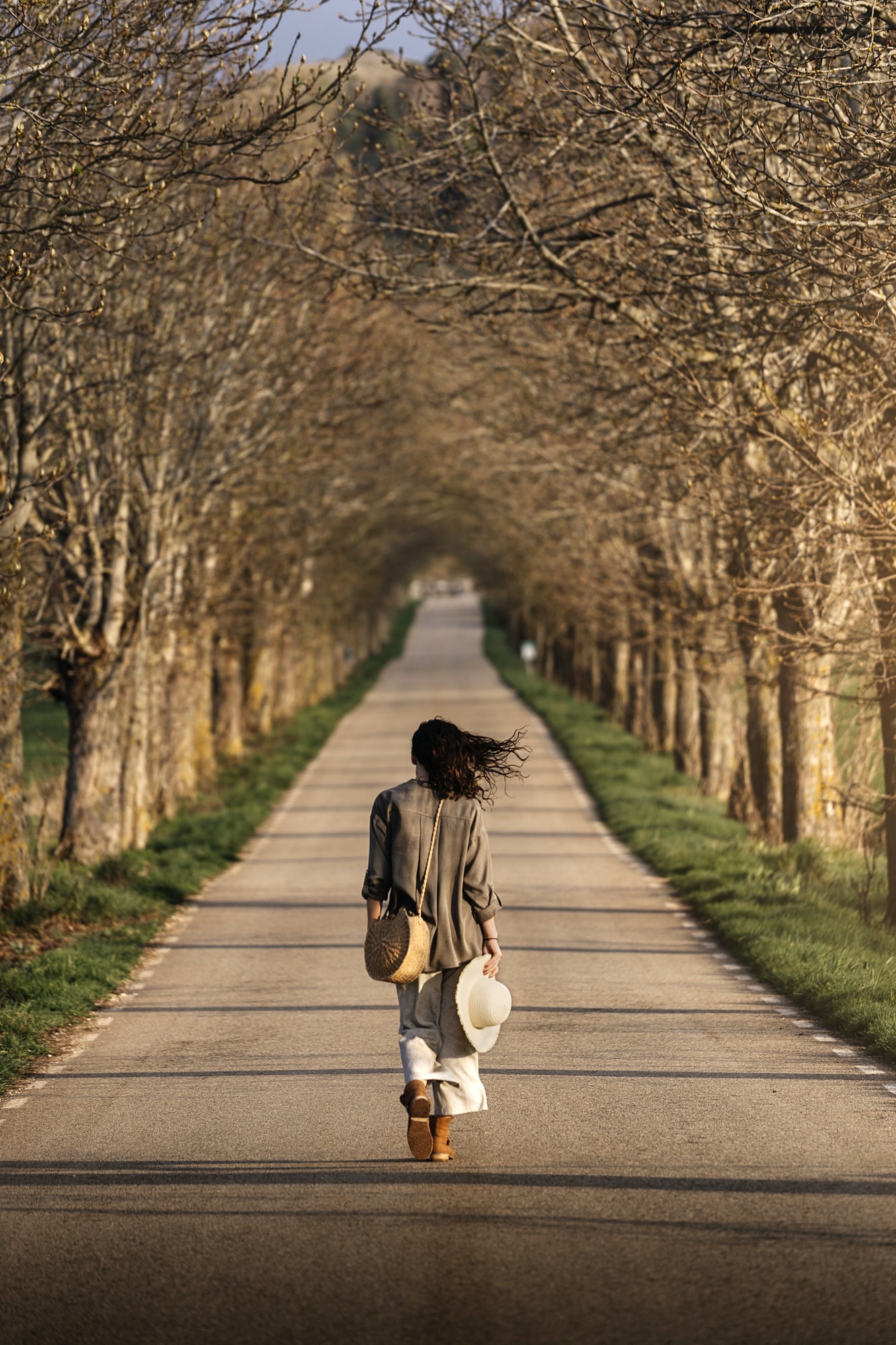 Back view of thoughtful woman walking