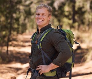 Hiking forest, fitness and portrait of man trekking in woods for freedom, peace or adventure journe