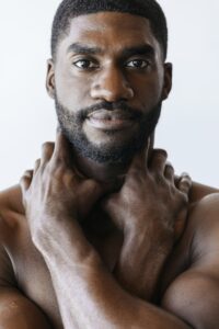 Man touching his neck