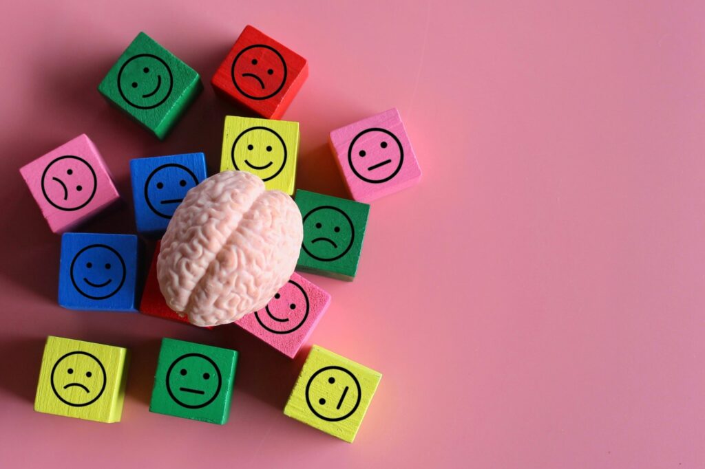 Human brain with happy, neutral and sad icon.